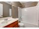 Standard bathroom with a single sink, vanity, toilet, and a shower-tub combination with white tile surround at 2432 N Talbott St, Indianapolis, IN 46205