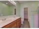 Bathroom with a double sink vanity, ample counter space, and a large mirror, and a separate tub at 2432 N Talbott St, Indianapolis, IN 46205