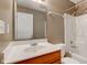 Standard bathroom with a single sink, vanity, toilet, and a shower-tub combination with white tile surround at 2432 N Talbott St, Indianapolis, IN 46205