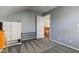 This cozy bedroom offers ample space with neutral walls, carpet flooring, and stairway access to the upper level at 2432 N Talbott St, Indianapolis, IN 46205