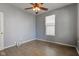 A view of a bedroom featuring wood-look flooring, a window and a ceiling fan at 2432 N Talbott St, Indianapolis, IN 46205