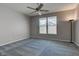 Bedroom with neutral walls, patterned carpet, a ceiling fan, and bright natural light from double windows at 2432 N Talbott St, Indianapolis, IN 46205