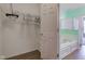 Well-organized walk-in closet offering ample storage space and access to bathroom with separate tub at 2432 N Talbott St, Indianapolis, IN 46205