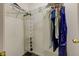 Well-organized closet space with hanging clothes, hanging shoe shelves, and metal racks for storage at 2432 N Talbott St, Indianapolis, IN 46205