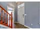 View of the home's entryway with wood floors, gray walls, and stairs with wooden railings at 2432 N Talbott St, Indianapolis, IN 46205