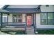 Charming front porch of home featuring storm door, painted steps, and a gray handrail at 2432 N Talbott St, Indianapolis, IN 46205