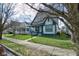 Traditional home with a cozy front porch and a neatly manicured lawn and sidewalk at 2432 N Talbott St, Indianapolis, IN 46205