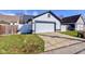Well-kept detached garage with a white door, matching siding, green grass, and a concrete driveway at 2432 N Talbott St, Indianapolis, IN 46205