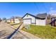 A well-kept detached two-car garage with a white door, matching siding, and green grass in the yard at 2432 N Talbott St, Indianapolis, IN 46205