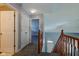Hallway featuring a wood railing leading to the front door at 2432 N Talbott St, Indianapolis, IN 46205