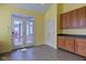 A dining area or kitchen with french doors opening to a deck or porch area and wooden cabinets at 2432 N Talbott St, Indianapolis, IN 46205
