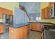 This is a kitchen with an island, stainless steel appliances, and an open view into a high-ceiling living area at 2432 N Talbott St, Indianapolis, IN 46205