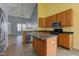 Kitchen with an island, wooden cabinets, stainless steel appliances, and views of the living room at 2432 N Talbott St, Indianapolis, IN 46205