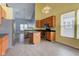 An open-concept kitchen featuring stainless steel appliances, an island, and a view to a high-ceiling living area at 2432 N Talbott St, Indianapolis, IN 46205