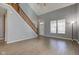 Bright and airy living room with vaulted ceilings, stairs, and large windows at 2432 N Talbott St, Indianapolis, IN 46205