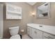 Bathroom with white vanity, stylish mirror, neutral walls, and a toilet at 3029 Oberlin Ct, Indianapolis, IN 46268