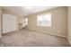 Spacious bedroom featuring plush carpet, closet, and large windows for natural light at 3029 Oberlin Ct, Indianapolis, IN 46268