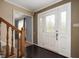 Inviting entryway with dark wood floors, a staircase with wooden railings, and a decorative glass front door at 3029 Oberlin Ct, Indianapolis, IN 46268