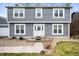 Charming two-story home features a tidy front lawn, stone walkway, and a decorative glass front door at 3029 Oberlin Ct, Indianapolis, IN 46268