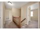 Bright hallway features neutral walls, carpet flooring, and an wooden banister at 3029 Oberlin Ct, Indianapolis, IN 46268