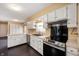 Bright eat-in kitchen featuring white cabinets, stainless steel appliances, and tile countertops at 3029 Oberlin Ct, Indianapolis, IN 46268