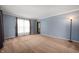 Cozy living room with soft carpet, blue accent wall, window, and decorative lamp at 3029 Oberlin Ct, Indianapolis, IN 46268