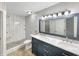 Updated bathroom features a double vanity, sleek fixtures, and a stand-up shower with neutral tile at 307 Beacon Point Ln, Fortville, IN 46040