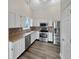 Modern kitchen with stainless steel appliances, updated cabinets, and stylish backsplash at 307 Beacon Point Ln, Fortville, IN 46040
