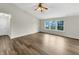 Bright living room with vaulted ceilings, ceiling fan, and hardwood floors at 307 Beacon Point Ln, Fortville, IN 46040