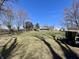 Large backyard featuring green grass and mature trees with a trailer in the corner at 3120 Central Ave, Anderson, IN 46016