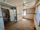 Bedroom with carpeted flooring, neutral walls with trim, and natural light from window at 3120 Central Ave, Anderson, IN 46016