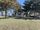 Exterior of house featuring a green lawn and mature trees in the yard at 3120 Central Ave, Anderson, IN 46016