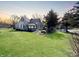 Charming home boasts a well-maintained lawn and a quaint enclosed porch at 3120 Central Ave, Anderson, IN 46016