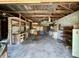 Spacious garage featuring wood ceiling, shelving, concrete block walls and cabinets at 3120 Central Ave, Anderson, IN 46016