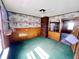 Spacious living room featuring decorative walls, brick column, and ceiling fan at 3120 Central Ave, Anderson, IN 46016