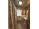 Compact bathroom with patterned shower curtain, tiled walls, and neutral flooring at 34 W Main St, Brownsburg, IN 46112
