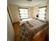 Bedroom featuring two beds, neutral walls, carpet, and two windows at 34 W Main St, Brownsburg, IN 46112