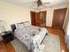 Cozy bedroom featuring hardwood floors, a ceiling fan, and a comfortable patterned bed at 34 W Main St, Brownsburg, IN 46112