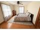 Bright bedroom with hardwood floors, area rug, patterned bedspread and neutral paint at 34 W Main St, Brownsburg, IN 46112