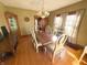 Bright dining room featuring hardwood floors, neutral colored walls, and a chandelier at 34 W Main St, Brownsburg, IN 46112