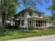 Charming two-story home with a screened in porch and a lush green yard at 34 W Main St, Brownsburg, IN 46112