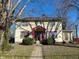 Charming two-story home featuring red framed windows, updated landscaping, and mature trees at 34 W Main St, Brownsburg, IN 46112