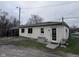 Back side of small beige house featuring large windows and a door at 34 W Main St, Brownsburg, IN 46112