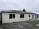 Beige small home with large windows and an outdoor seating area at 34 W Main St, Brownsburg, IN 46112