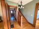 Welcoming hallway with hardwood floors, wood trim, and open staircase at 34 W Main St, Brownsburg, IN 46112