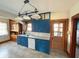 Bright kitchen featuring custom blue cabinets, white appliances, and natural wood trim at 34 W Main St, Brownsburg, IN 46112