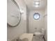 Bathroom features a vanity, decorative mirror, and octagon window for natural light at 3509 River Bluff Rd, Anderson, IN 46012