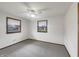 Light and airy bedroom with two windows, ceiling fan and neutral carpeting at 3509 River Bluff Rd, Anderson, IN 46012