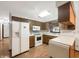 Bright kitchen with white appliances, light countertops, and wood cabinets at 3509 River Bluff Rd, Anderson, IN 46012