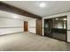 Bright living room with neutral carpet, wood beam accent, and sliding glass door to outdoors at 3509 River Bluff Rd, Anderson, IN 46012